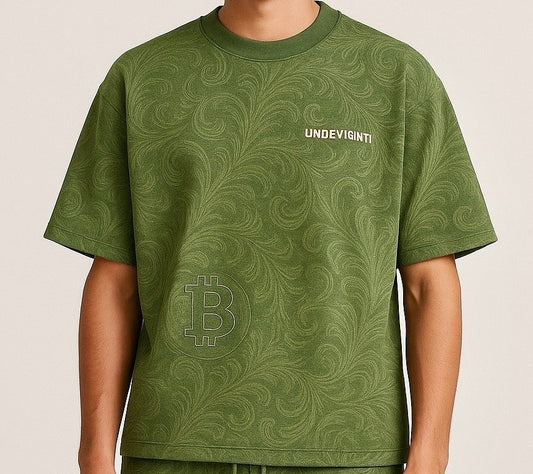 Green crew neck t-shirt crafted with premium cotton, featuring a Bitcoin symbol and 'UNDEVIGNI' branding on a green print artwork.