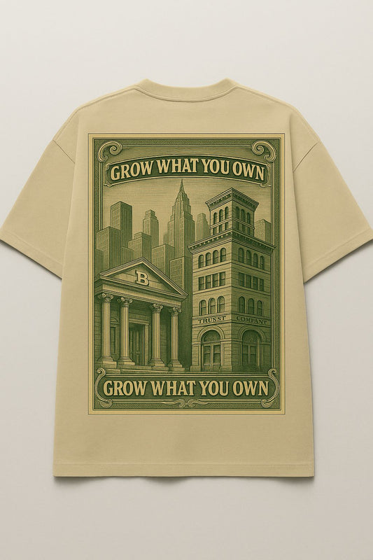 Beige t-shirt with green graphic and text 'Grow What You Own' on a light gray background
